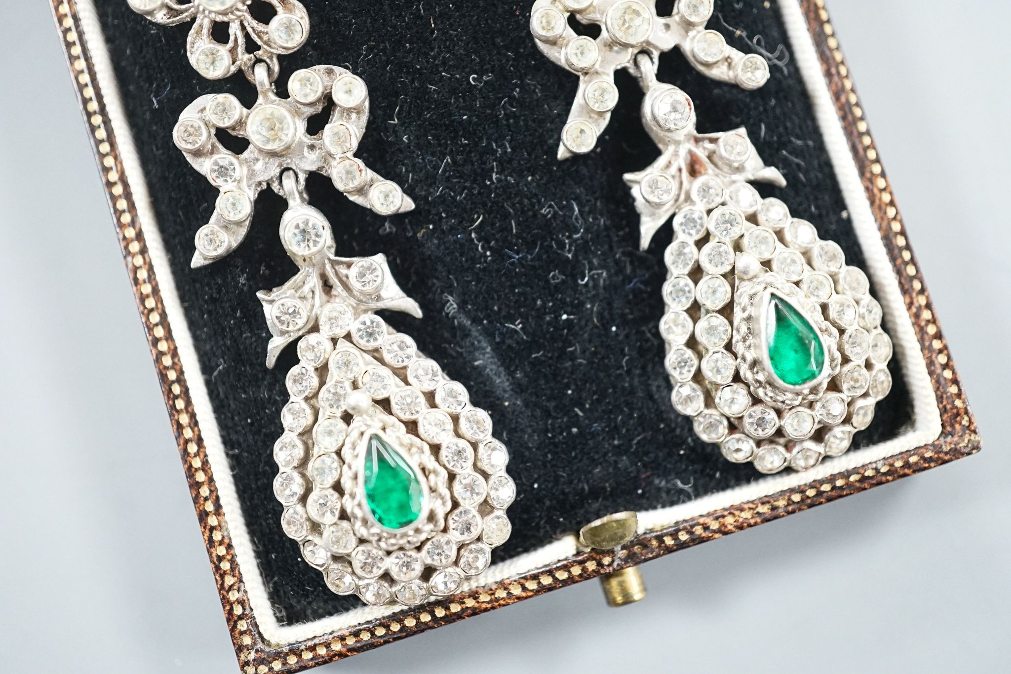 A pair of white metal and two colour paste drop earrings, 68mm, in a gilt tooled leather box.